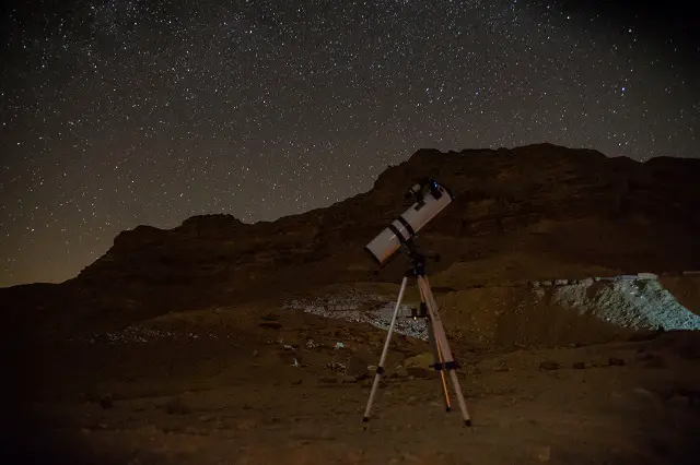 Telescope at night with starry sky