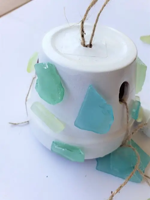 Decorating the large pot with sea glass